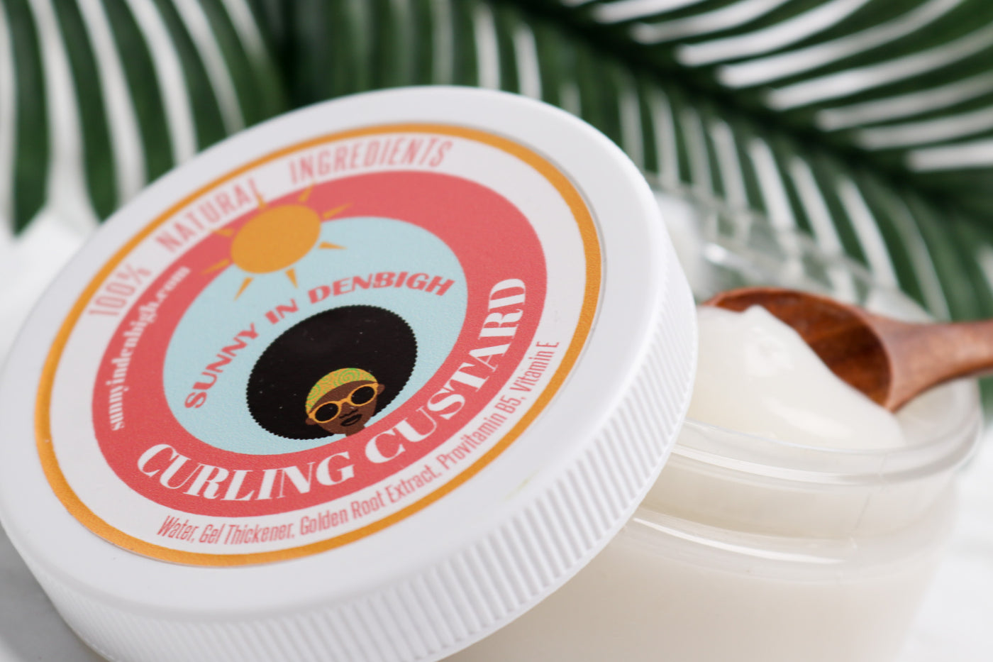 Sunny In Denbigh Curling Custard The Sunny In Denbigh Curling Custard gives moisture and curl definition, hold and brilliant shiny hair! Utilizing the humectant properties of Shea Butter, Olive Oil, Gel Thickener, and Vitamin E, our Curling Custard will give weight to your hair, define your curls, remove frizz, provide long-lasting hold and shine without ever being greasy, crunchy or drying.